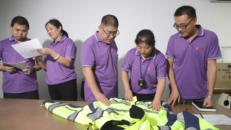 BOWINS team checks a safety workwear sample and production documents